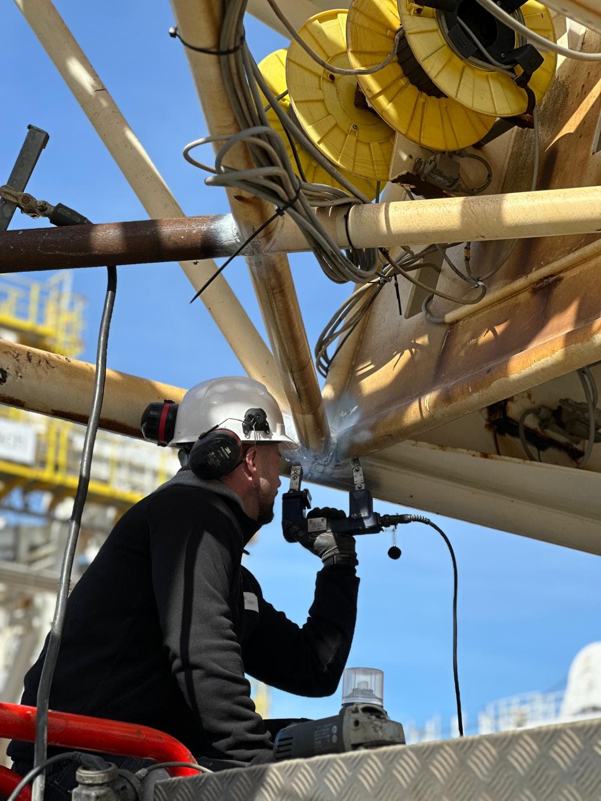 NDT inspector examining structure of a metal part using magnetic particle inspection tool