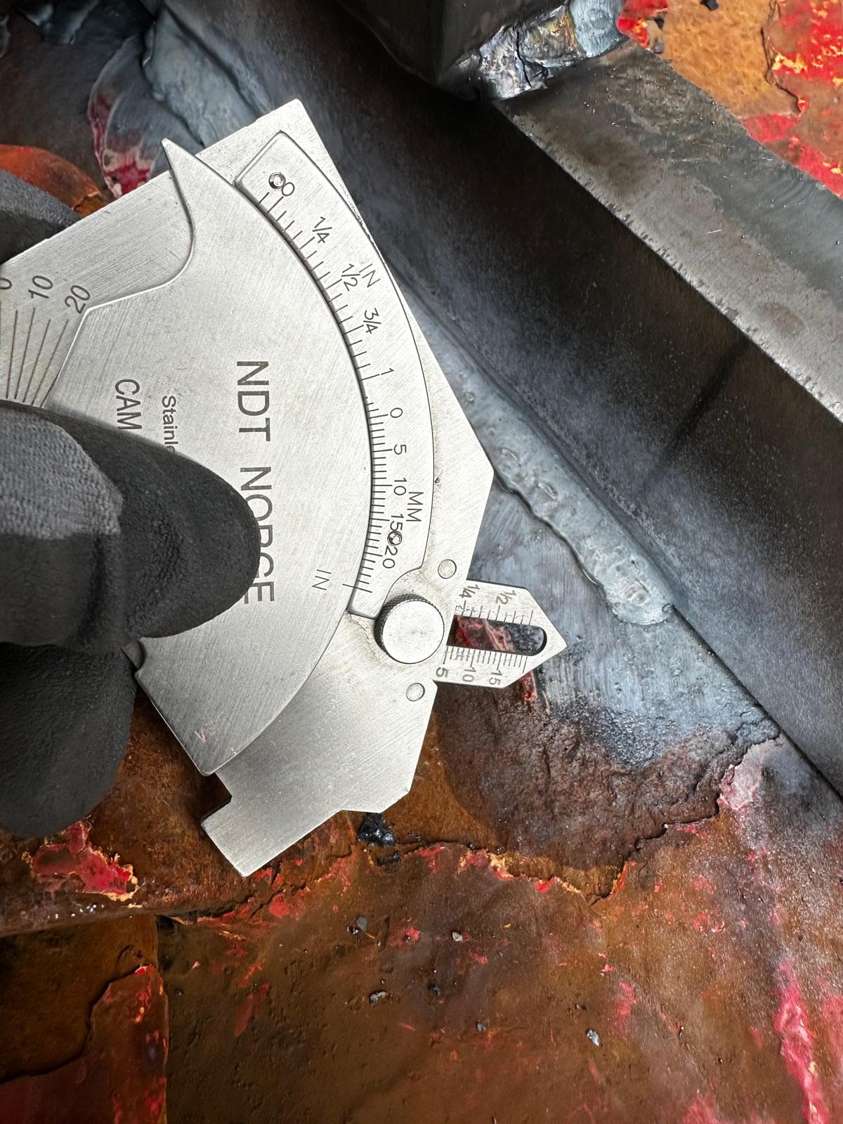NDT inspector examining a metal pipe