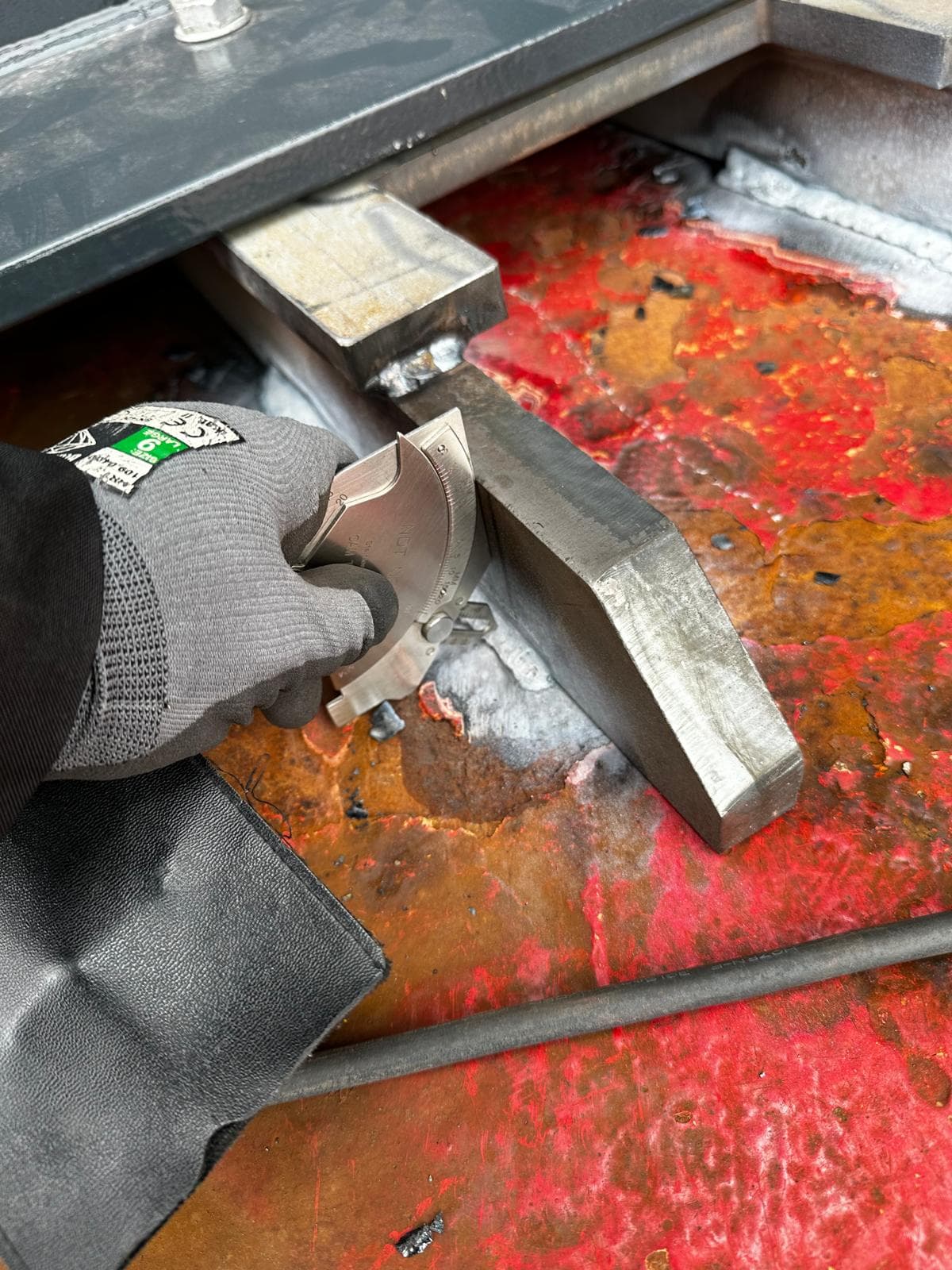 NDT inspector examining a large round metal part.